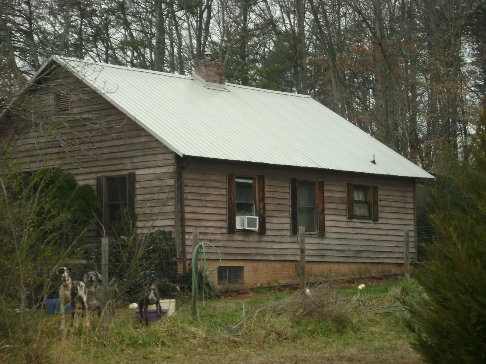White metal roof on an old wood sided farmhouse, from a Metal Roof Installation job in Rutherford